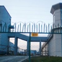 A perimeter fence stands around what is officially known as a vocational skills education center in Dabancheng, in China's Xinjiang Uyghur Autonomous Region, in 2018.  | REUTERS